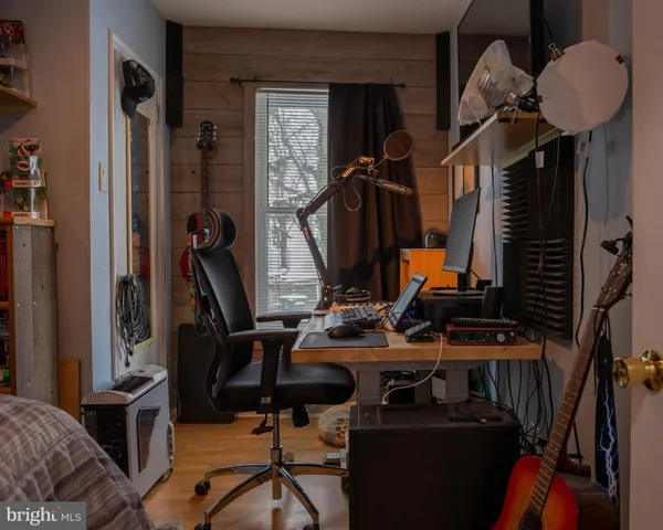 a bedroom with a bed and a flat tv screen