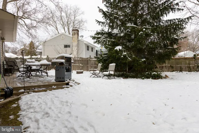 a bedroom with a bed and large windows