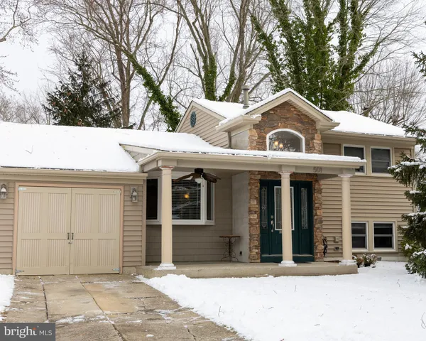 a view of a patio with snow on the road