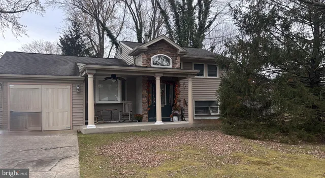 a view of porch with a table and chairs and potted plants
