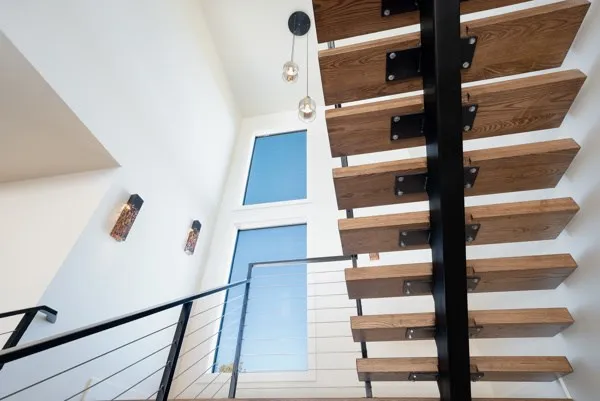 a view of staircase with white walls and a window