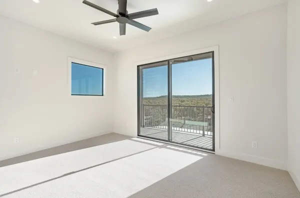 a view of room with window and ceiling fan