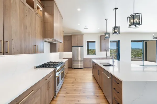 a kitchen with stainless steel appliances a sink stove and cabinets