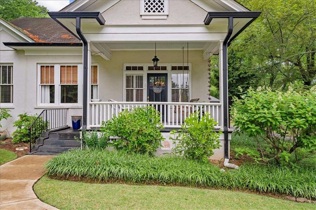 106 Westmore Road Southwest Rome, GA 30165 - Photo 52 of 56 a view of a porch with a floor to ceiling window and potted plants