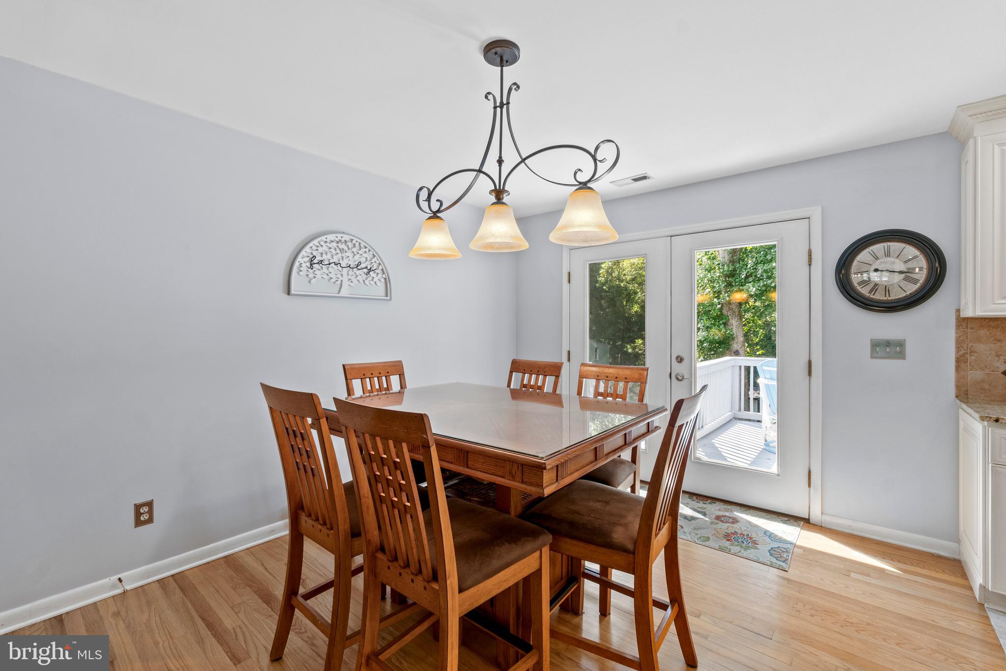 1706 Abelia Road Fallston, MD 21047 - Photo 11 of 41 a view of a dining room with furniture wooden floor and a chandelier