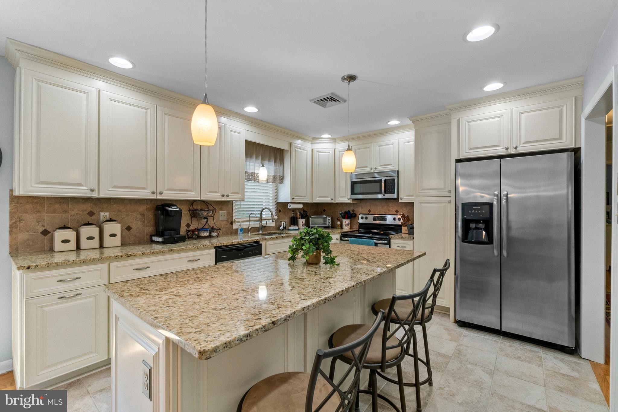 1706 Abelia Road Fallston, MD 21047 - Photo 15 of 41 a kitchen with stainless steel appliances granite countertop a refrigerator a sink a stove a dining table and chairs