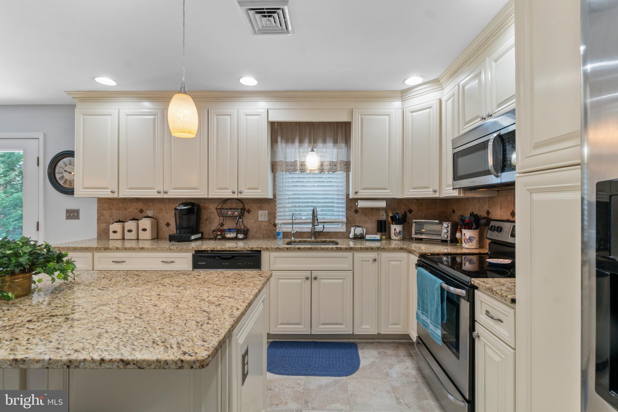1706 Abelia Road Fallston, MD 21047 - Photo 16 of 41 a kitchen with stainless steel appliances granite countertop a stove sink and cabinets