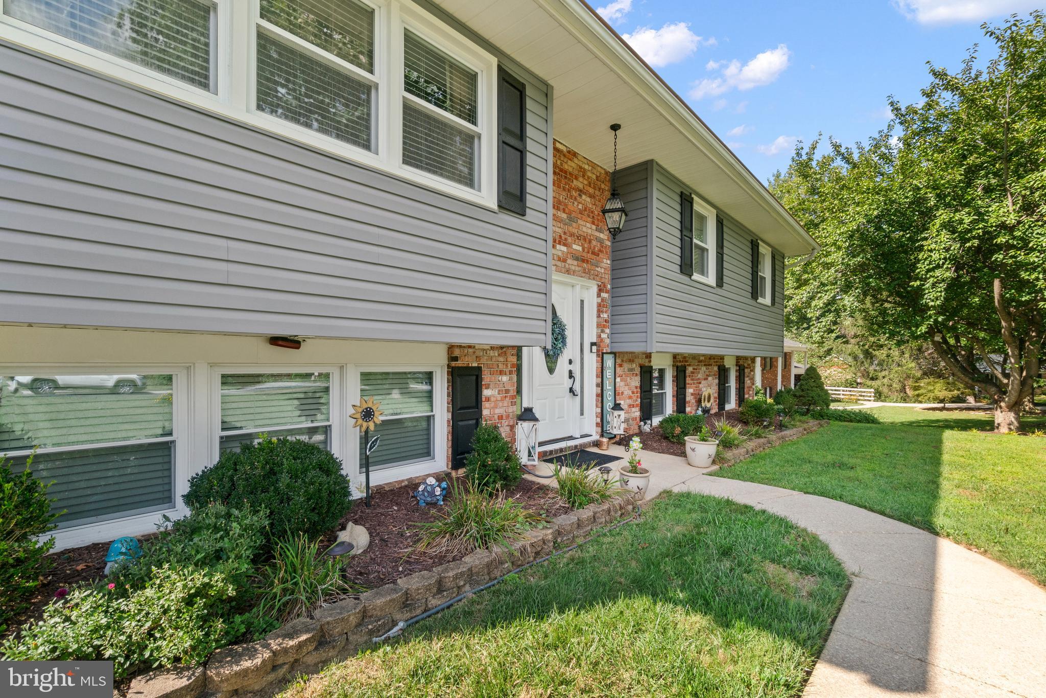 1706 Abelia Road Fallston, MD 21047 - Photo 5 of 41 a front view of house with a garden and sitting area