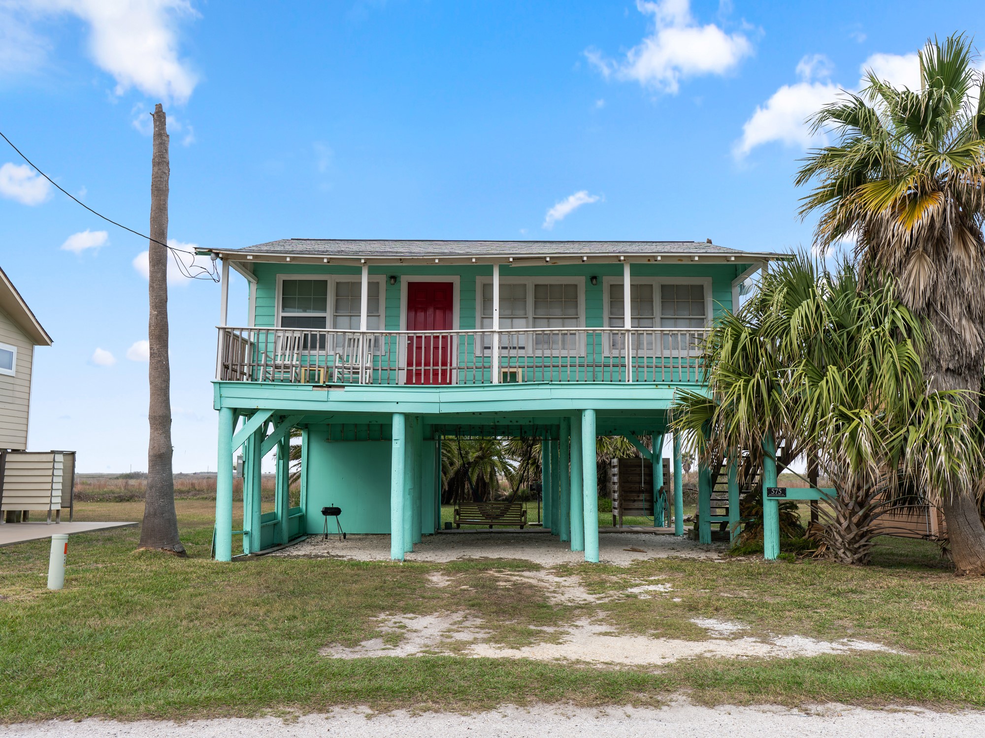575 Beach Front Drive Matagorda, TX 77457 - Photo 2 of 39 a view of a house with a yard and plants
