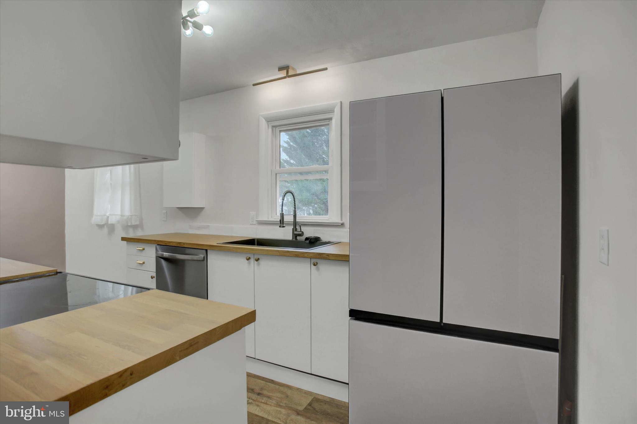 10894 Grindstone Hill Road Greencastle, PA 17225 - Photo 12 of 43 a kitchen with stainless steel appliances granite countertop a refrigerator and a sink