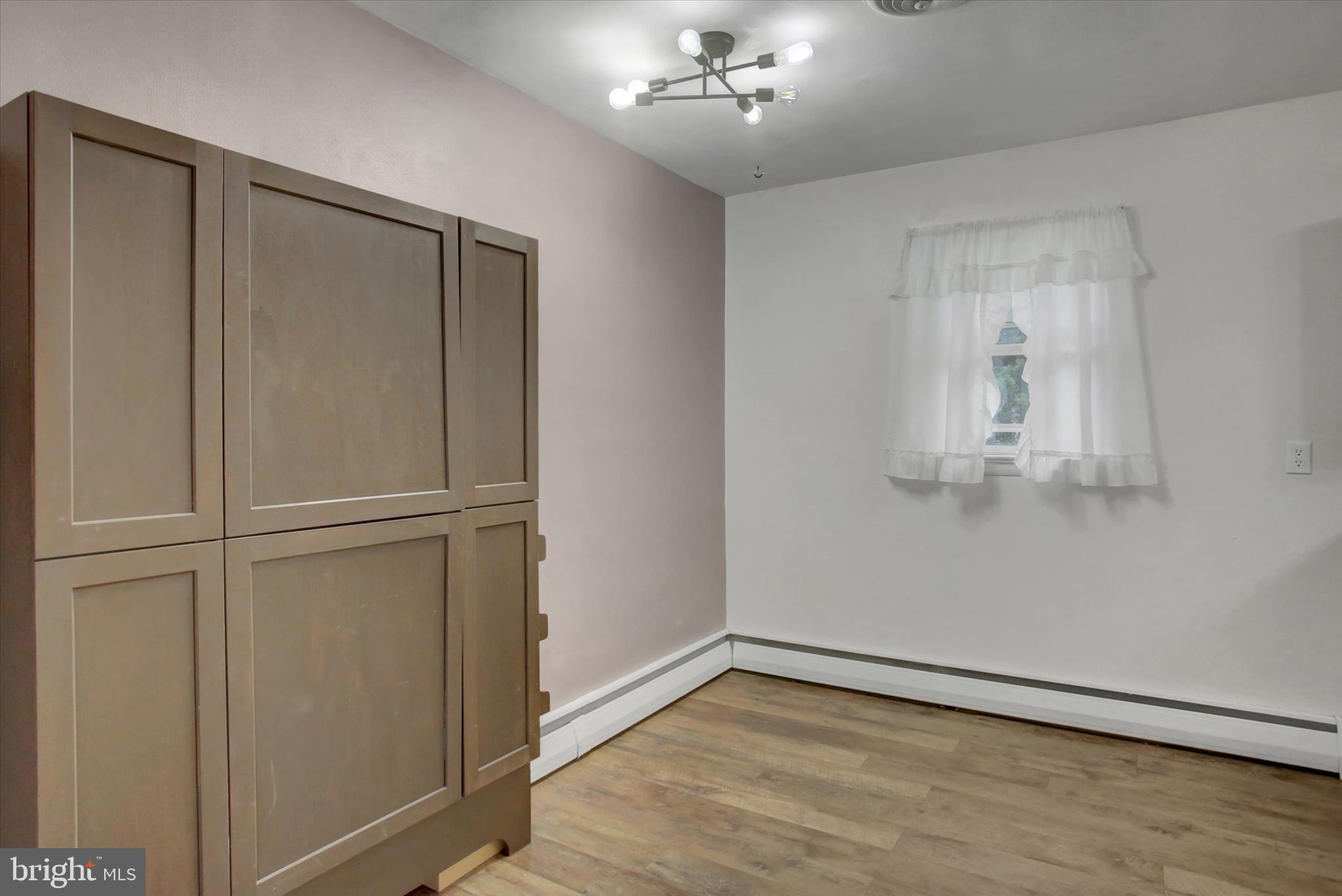 10894 Grindstone Hill Road Greencastle, PA 17225 - Photo 15 of 43 a view of an empty room with wooden floor and a window
