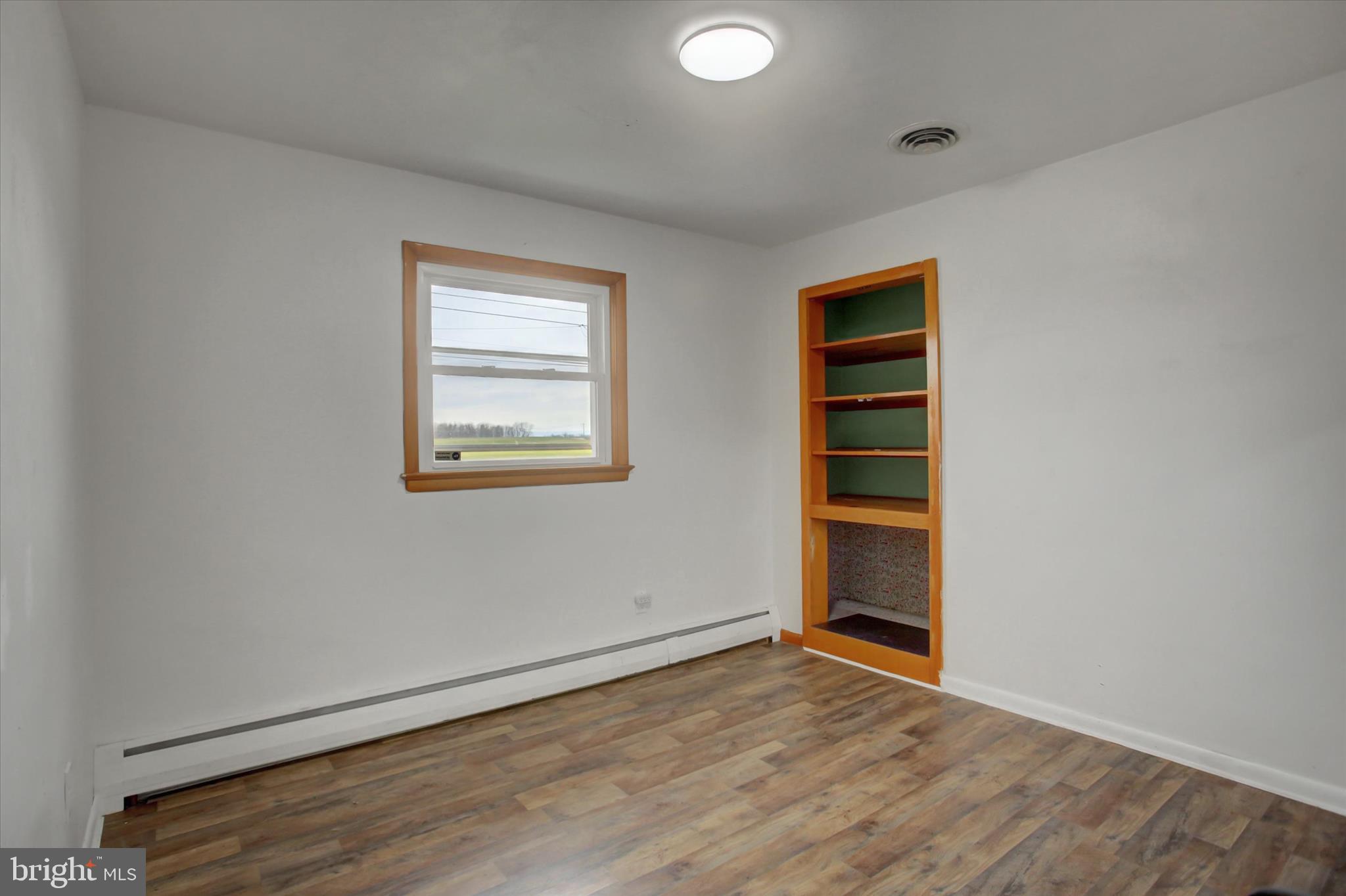 10894 Grindstone Hill Road Greencastle, PA 17225 - Photo 24 of 43 an empty room with wooden floor and window