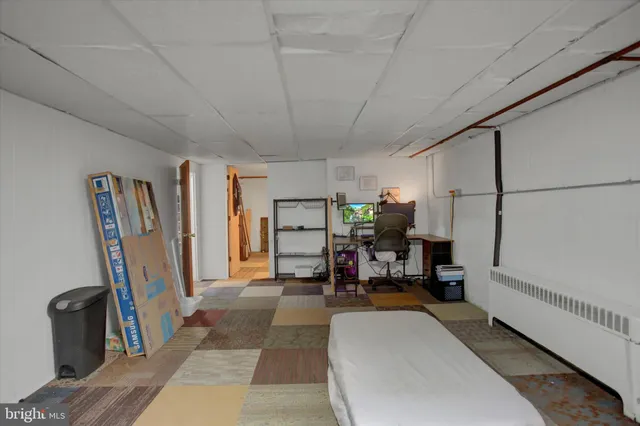 a bedroom with a bed and a chair