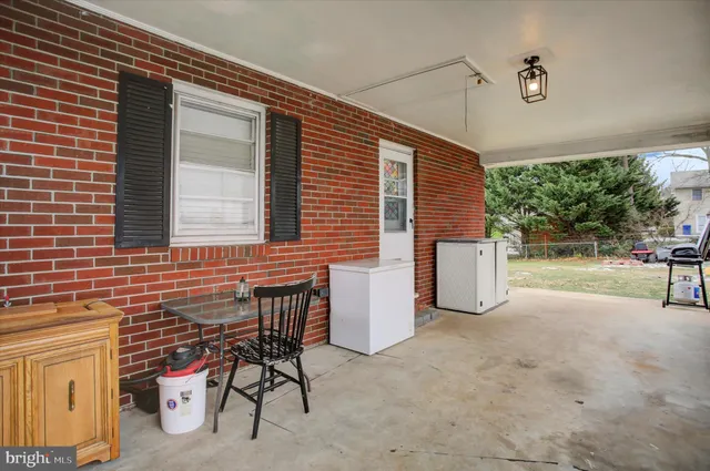 a view of a house with a yard and sitting area