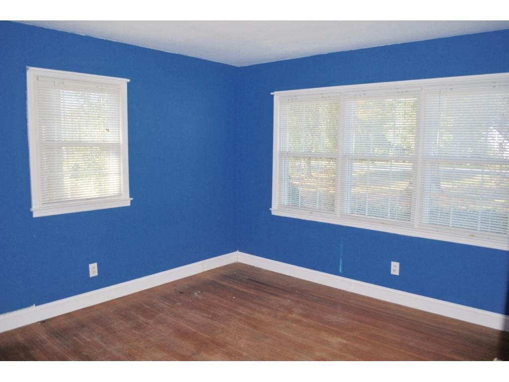 3212 Oak Ridge Road Summerfield, NC 27358 - Photo 12 of 22 a view of an empty room with wooden floor and a window