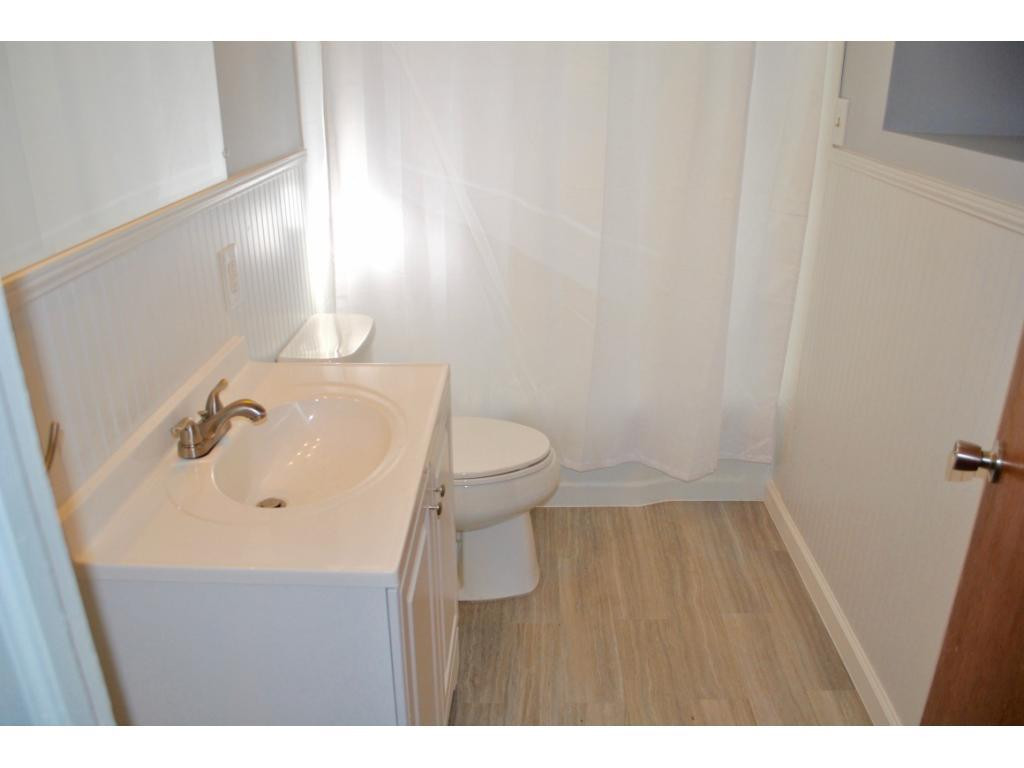 3212 Oak Ridge Road Summerfield, NC 27358 - Photo 14 of 22 a bathroom with a sink a toilet and a mirror