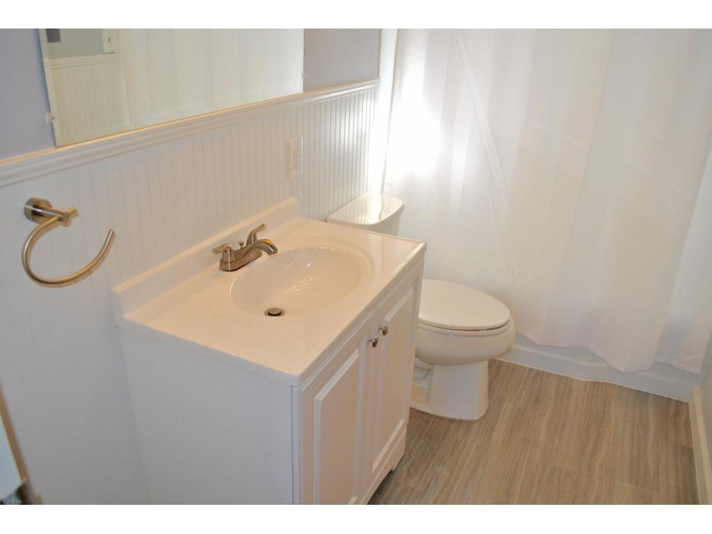 3212 Oak Ridge Road Summerfield, NC 27358 - Photo 15 of 22 a bathroom with a sink a toilet and a mirror
