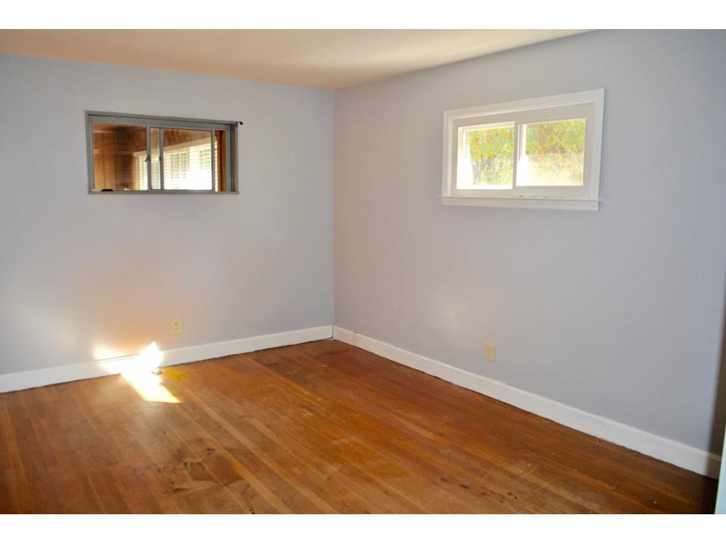 3212 Oak Ridge Road Summerfield, NC 27358 - Photo 16 of 22 a view of an empty room with wooden floor and a window
