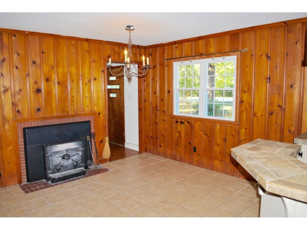 3212 Oak Ridge Road Summerfield, NC 27358 - Photo 4 of 22 a bedroom with a bed and a fireplace