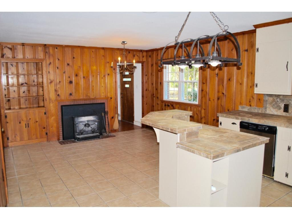 3212 Oak Ridge Road Summerfield, NC 27358 - Photo 5 of 22 a kitchen with a sink a counter top space and a fireplace