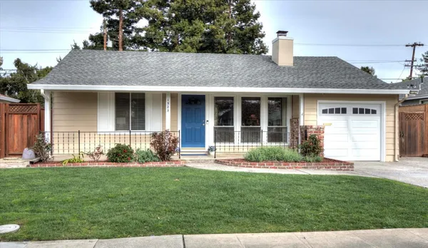 a front view of a house with a yard and green space