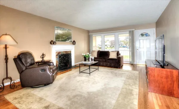 a living room with furniture a flat screen tv and a fireplace