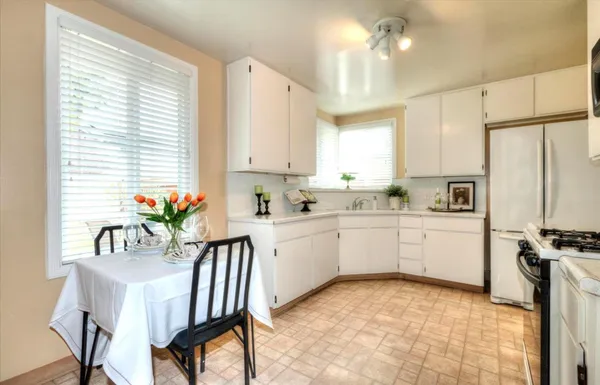 a kitchen with a sink cabinets and window