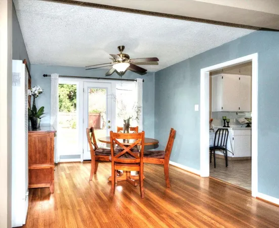 a view of a dining room with furniture wooden floor and a chandelier