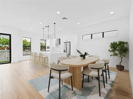 a view of a dining room with furniture and wooden floor