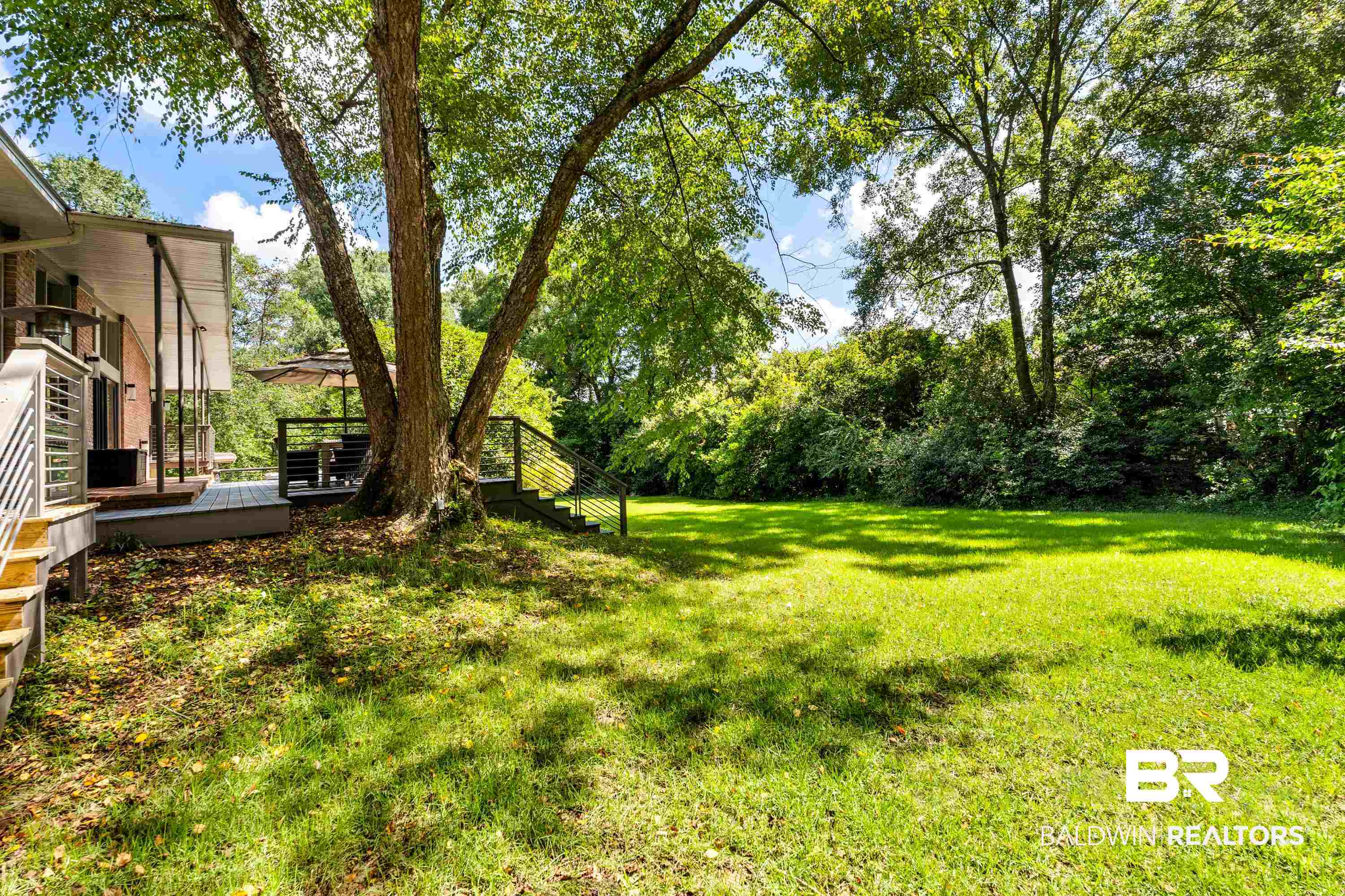 233 Suzanne Circle Mobile, AL 36608 - Photo 49 of 85 View of grassy yard featuring a wooden deck and stairs