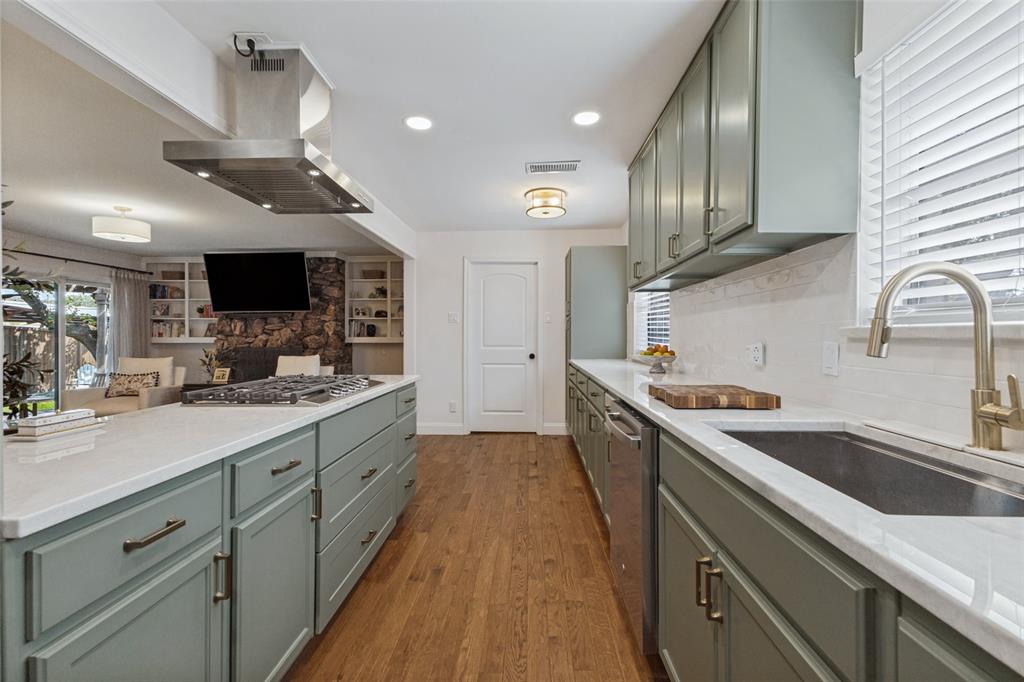 9864 Shoreview Road Dallas, TX 75238 - Photo 13 of 24 Kitchen featuring an expansive island with cooktop, stainless steel range hood, full-height backsplash, wood-finish flooring, and recessed lighting