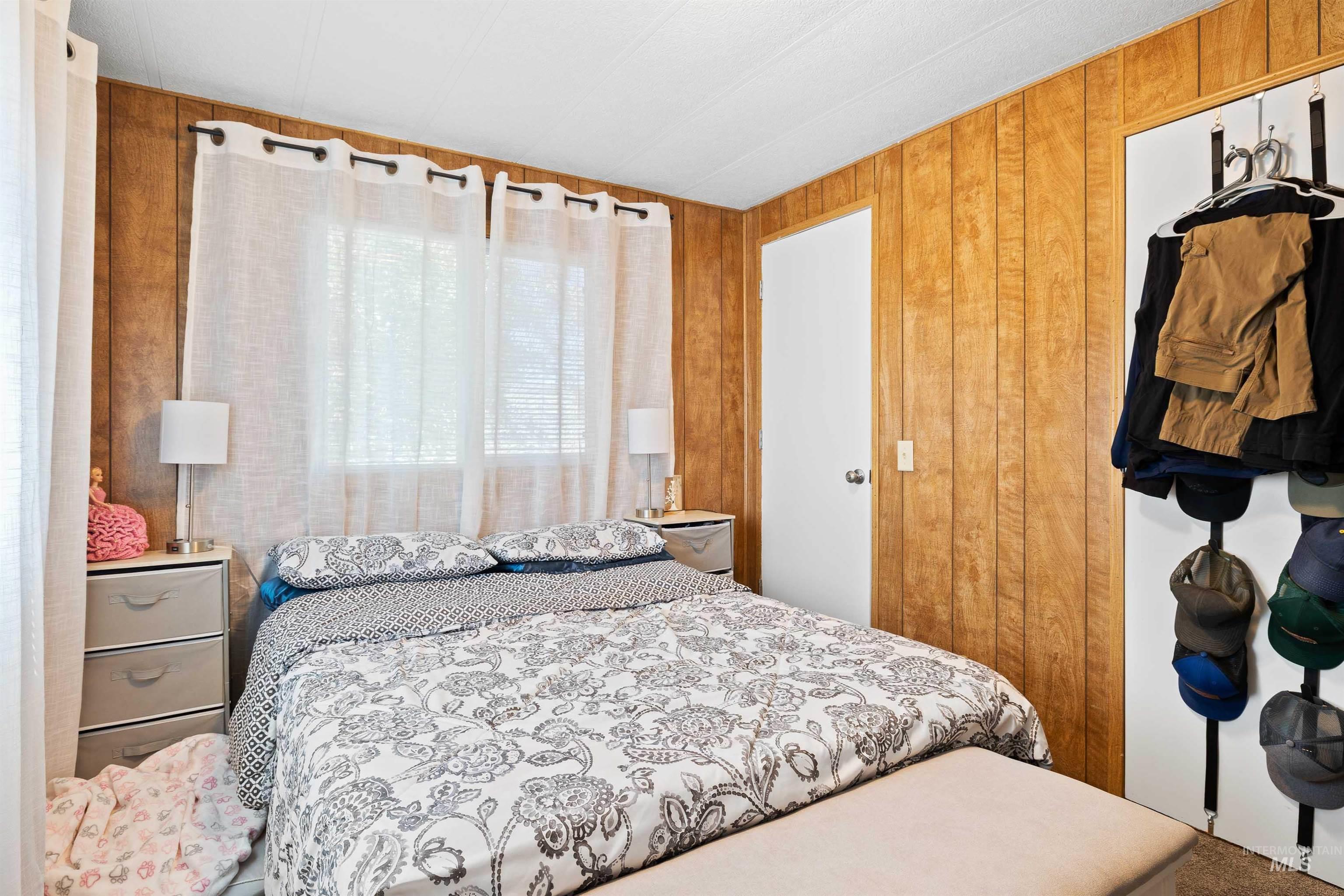 198 South Hills Road, Unit 115 Twin Falls, ID 83301 - Photo 12 of 22 Bedroom featuring wooden walls