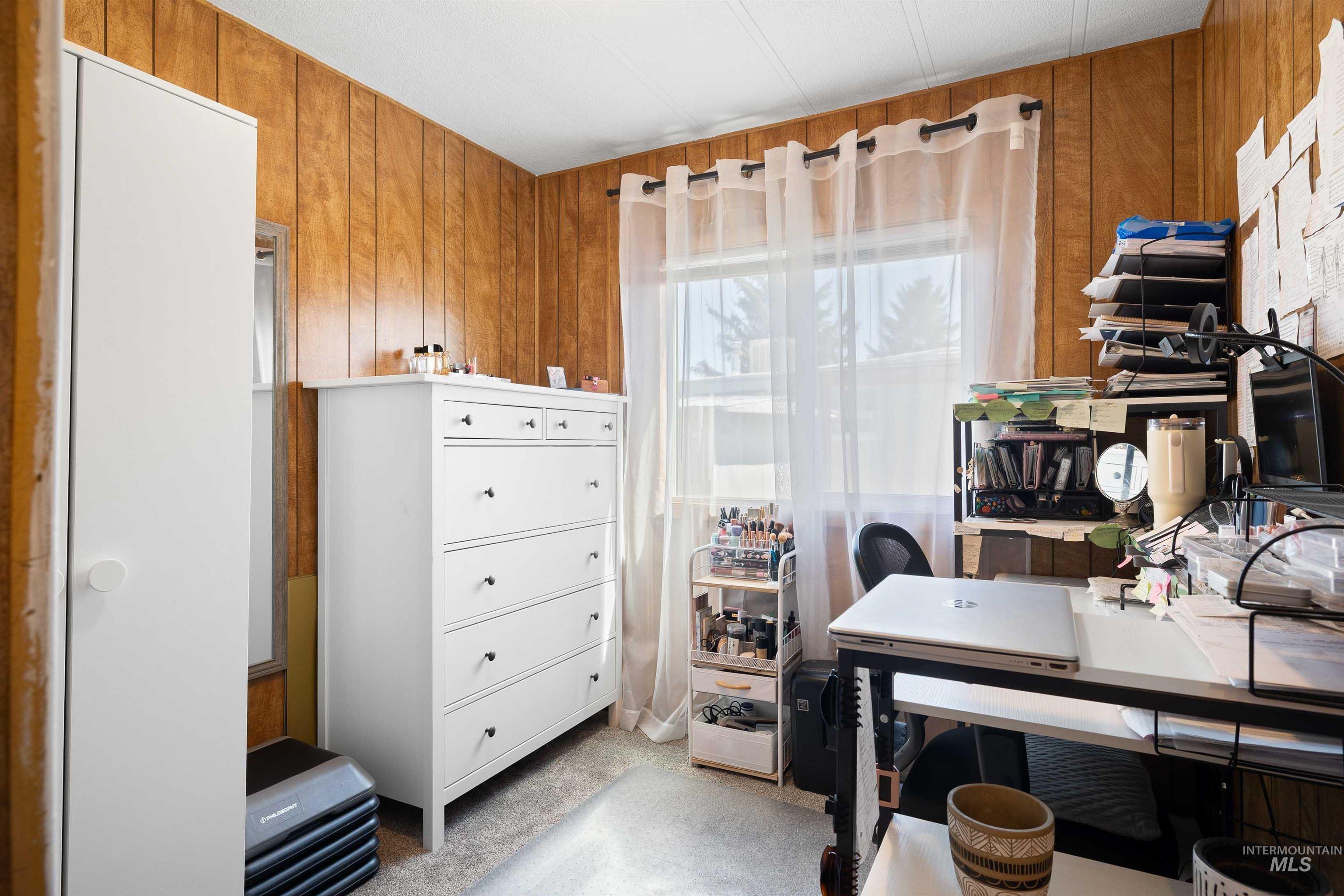 198 South Hills Road, Unit 115 Twin Falls, ID 83301 - Photo 14 of 22 Home office featuring wood walls and light carpet