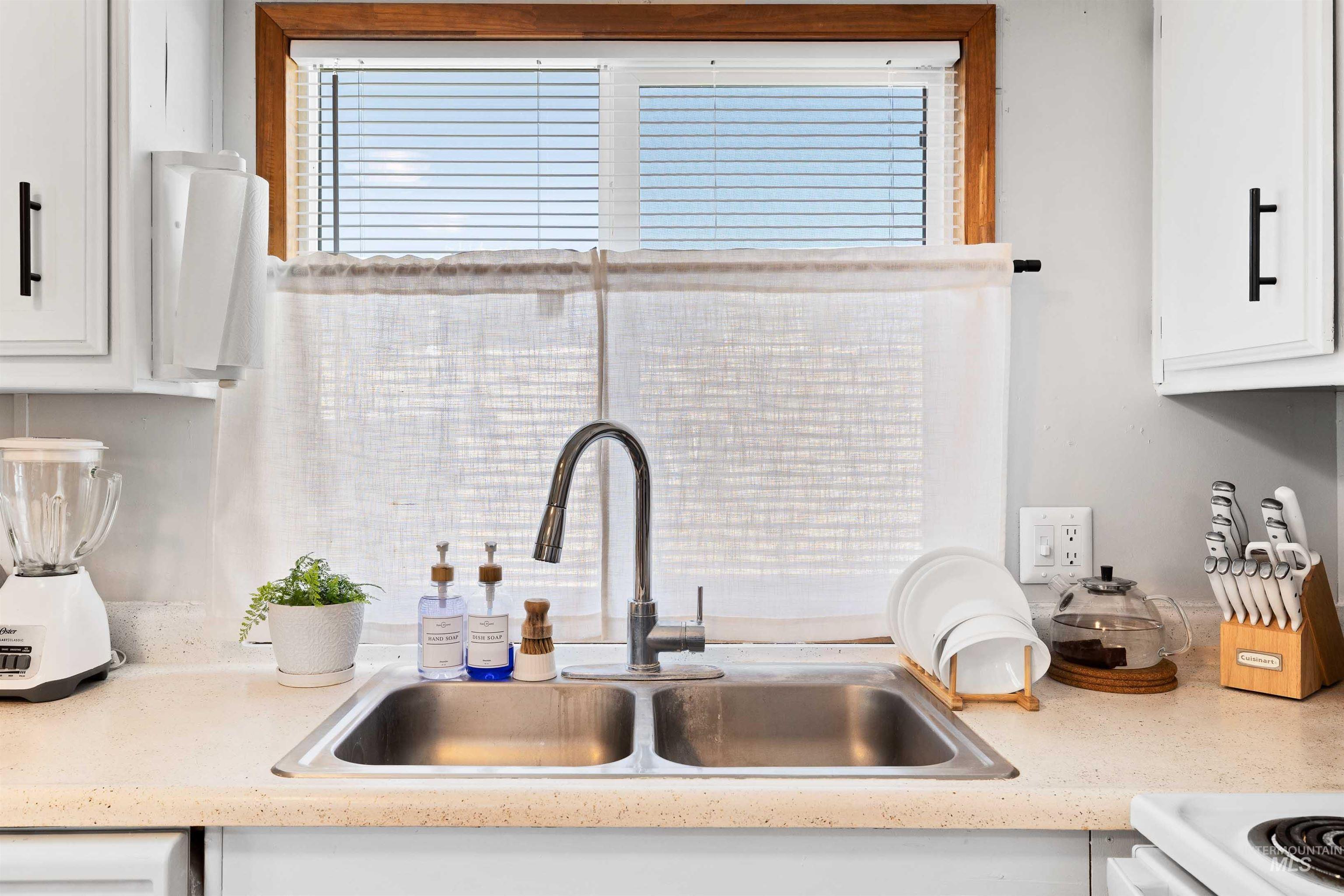 198 South Hills Road, Unit 115 Twin Falls, ID 83301 - Photo 6 of 22 Kitchen view of white cabinetry and light countertops
