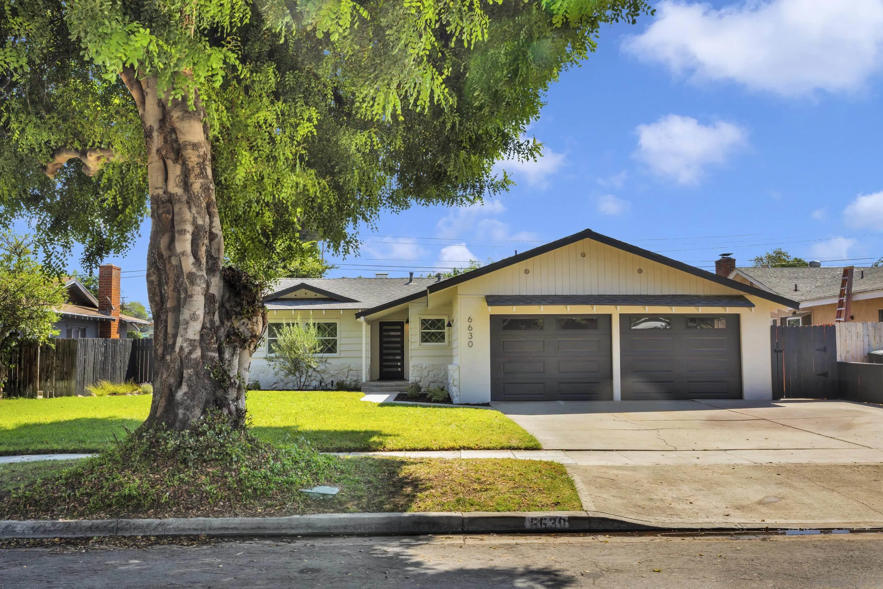 6630 Montclair Drive Riverside, CA 92504 - Photo 2 of 47 a front view of a house with a garden and yard
