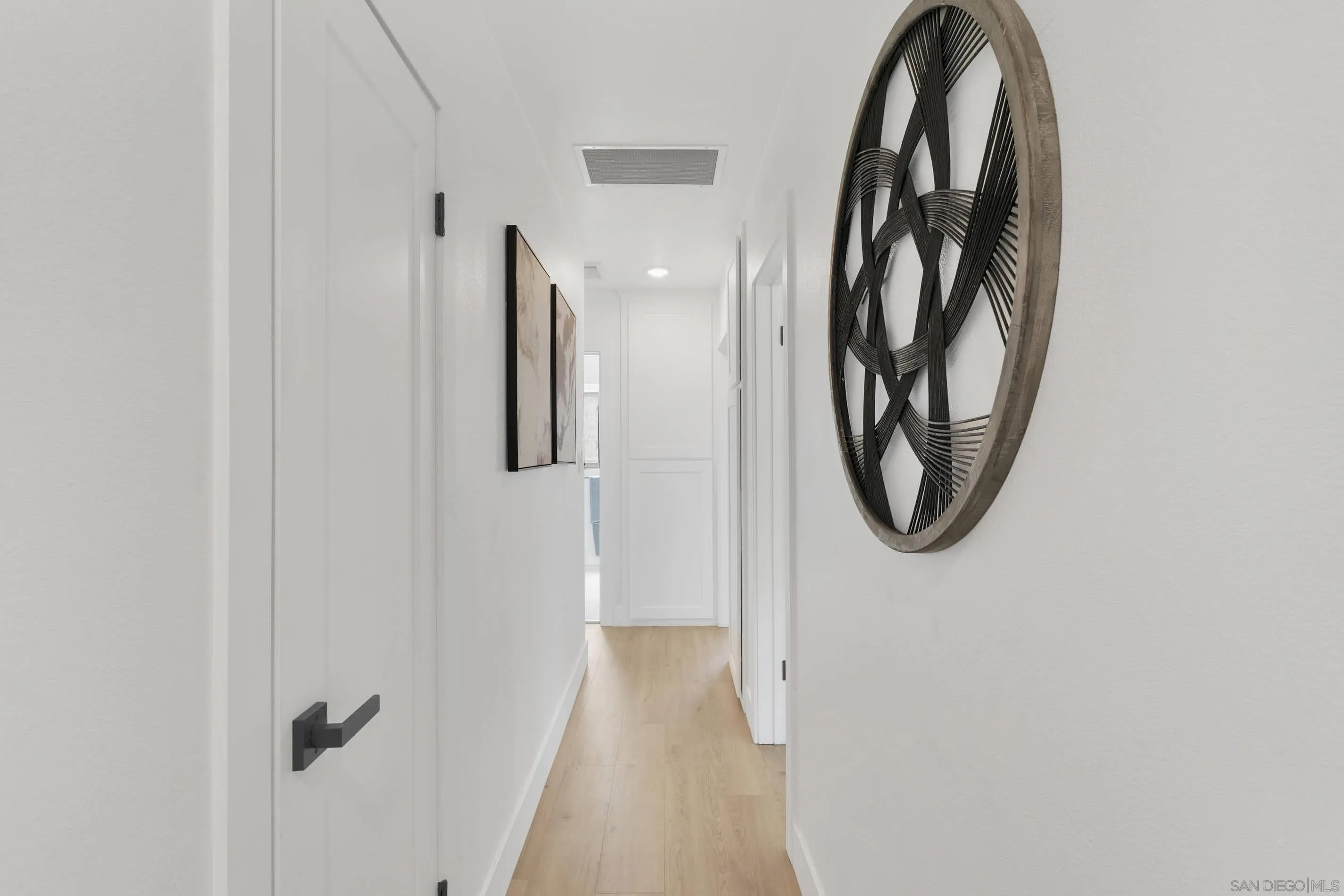 6630 Montclair Drive Riverside, CA 92504 - Photo 21 of 47 a view of a hallway with wooden floor