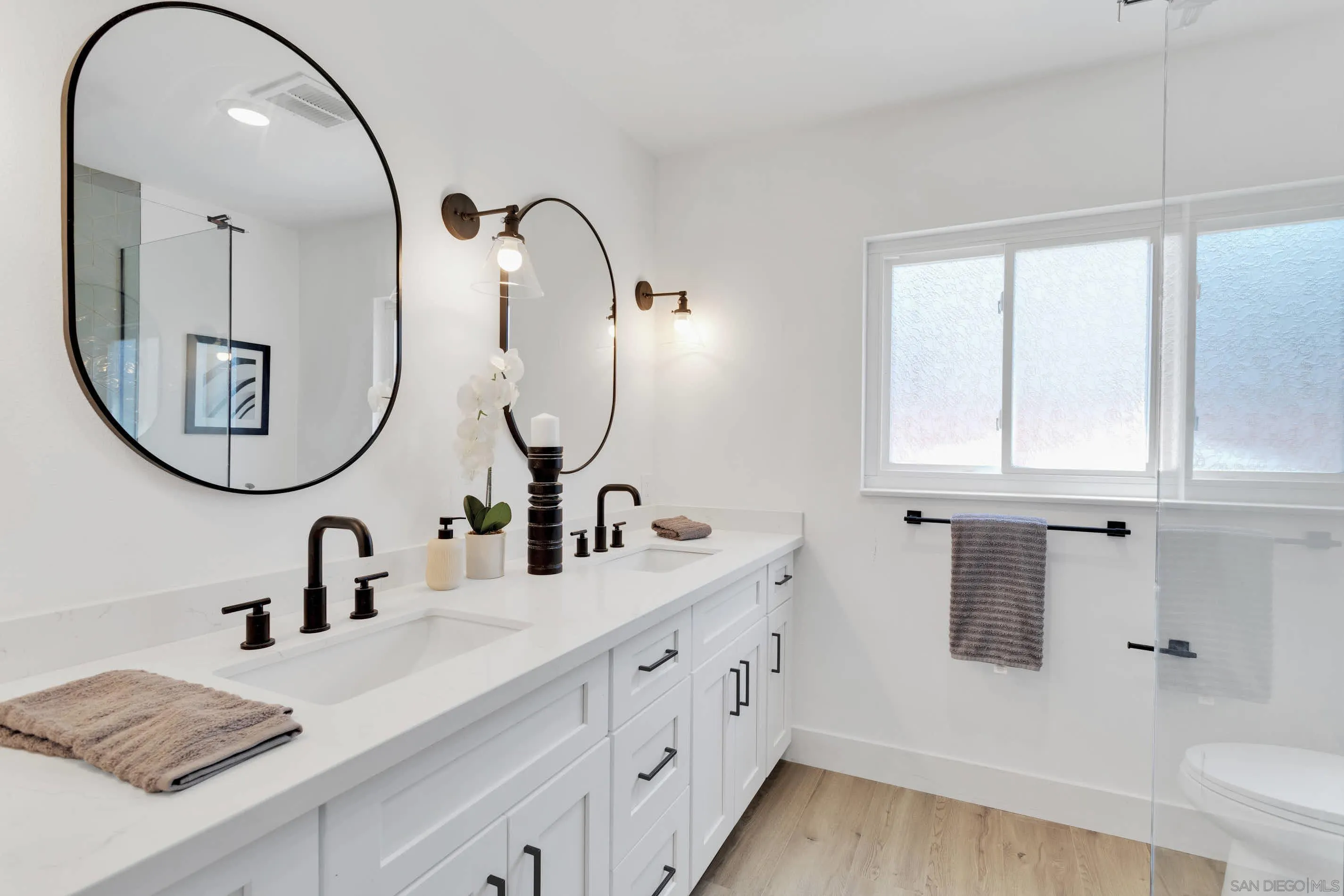 6630 Montclair Drive Riverside, CA 92504 - Photo 28 of 47 a bathroom with a double vanity sink and a mirror