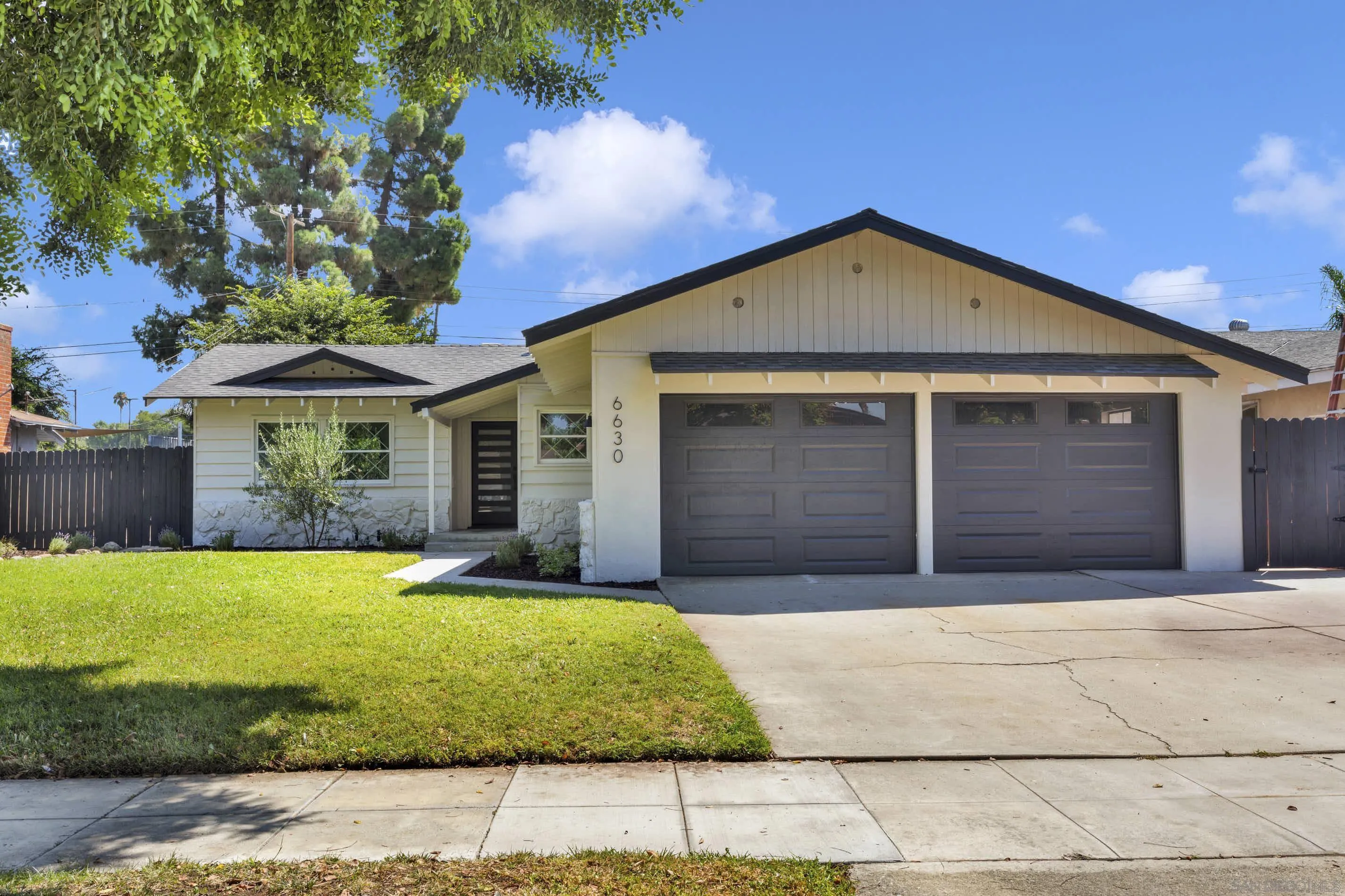 6630 Montclair Drive Riverside, CA 92504 - Photo 3 of 47 a front view of a house with a yard and garage