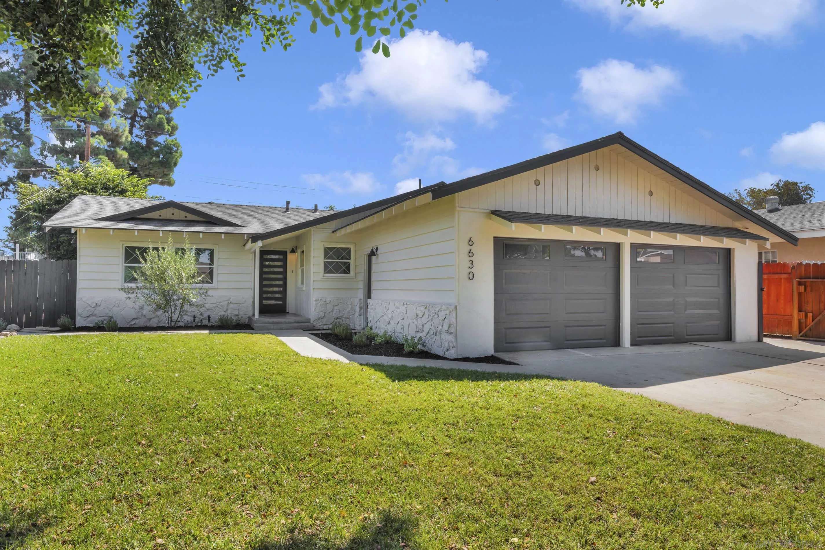 6630 Montclair Drive Riverside, CA 92504 - Photo 4 of 47 a view of a house with a yard and garage
