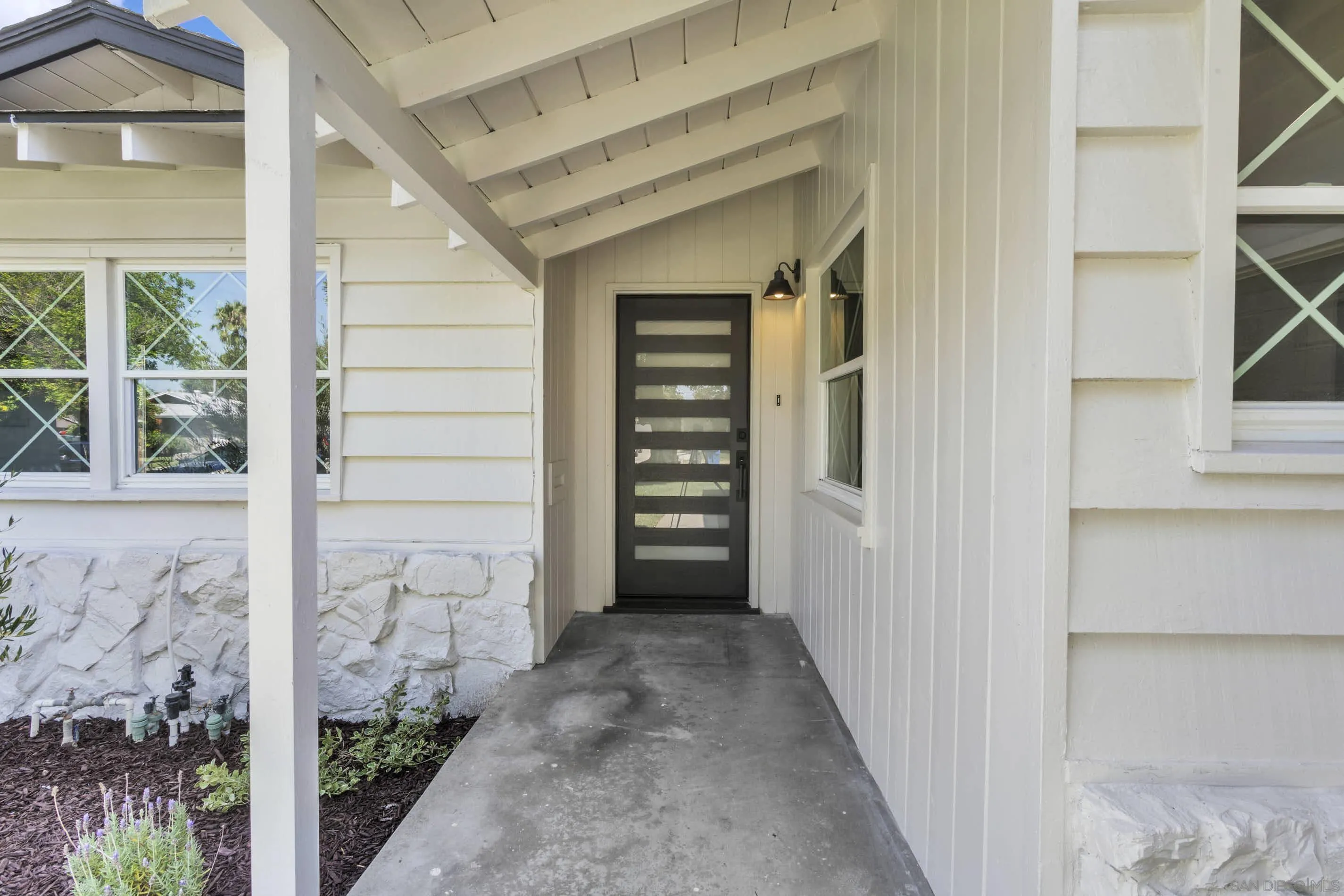 6630 Montclair Drive Riverside, CA 92504 - Photo 6 of 47 a view of a hallway with wooden walls and entryway