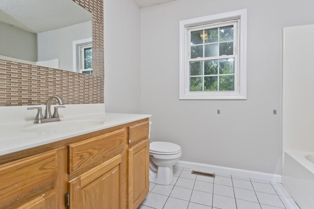 23 Martha Street Springfield, MA 01151 - Photo 12 of 19 a bathroom with a sink a toilet and a window