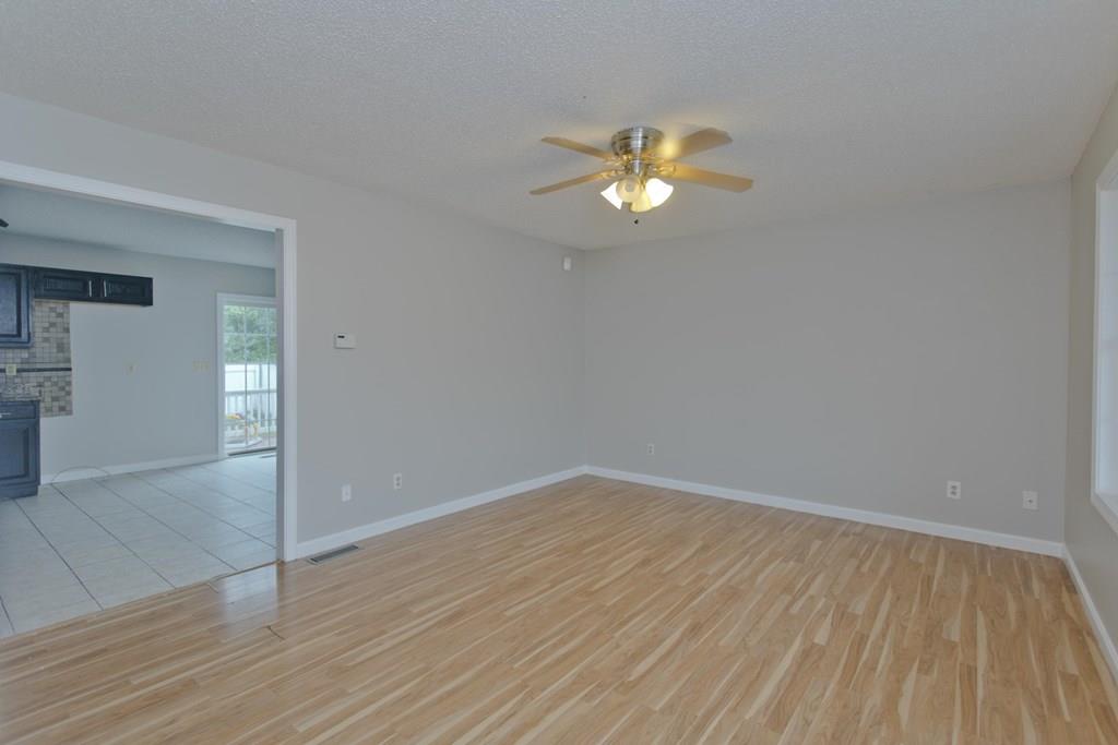23 Martha Street Springfield, MA 01151 - Photo 3 of 19 a view of empty room with wooden floor and ceiling fan