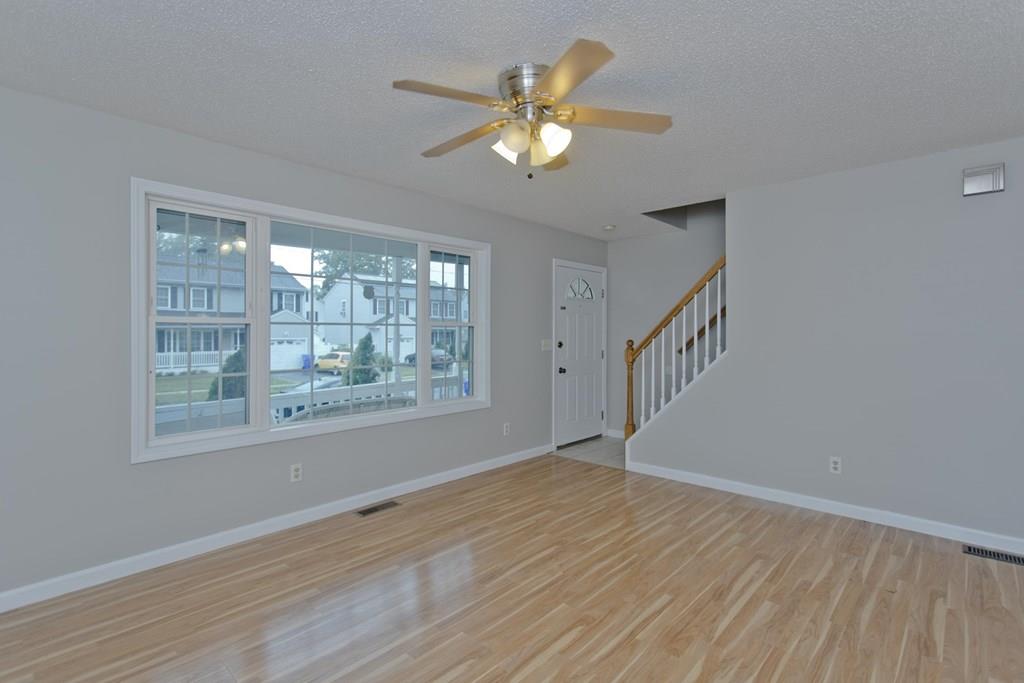 23 Martha Street Springfield, MA 01151 - Photo 4 of 19 a view of an empty room with wooden floor and a window
