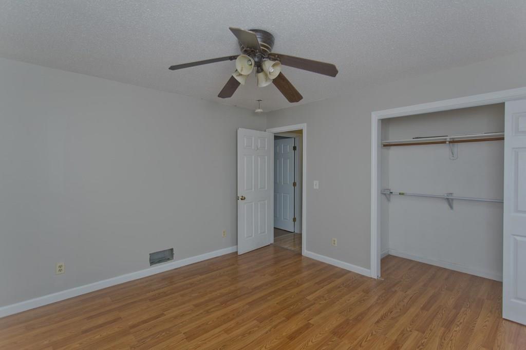 23 Martha Street Springfield, MA 01151 - Photo 9 of 19 a view of empty room with wooden floor and ceiling fan