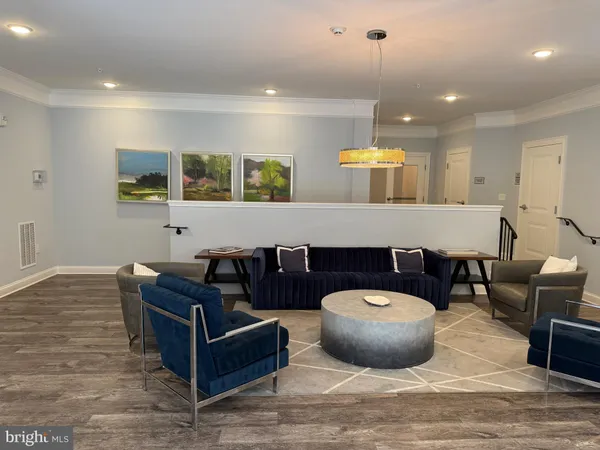 a living room with furniture a window and kitchen view