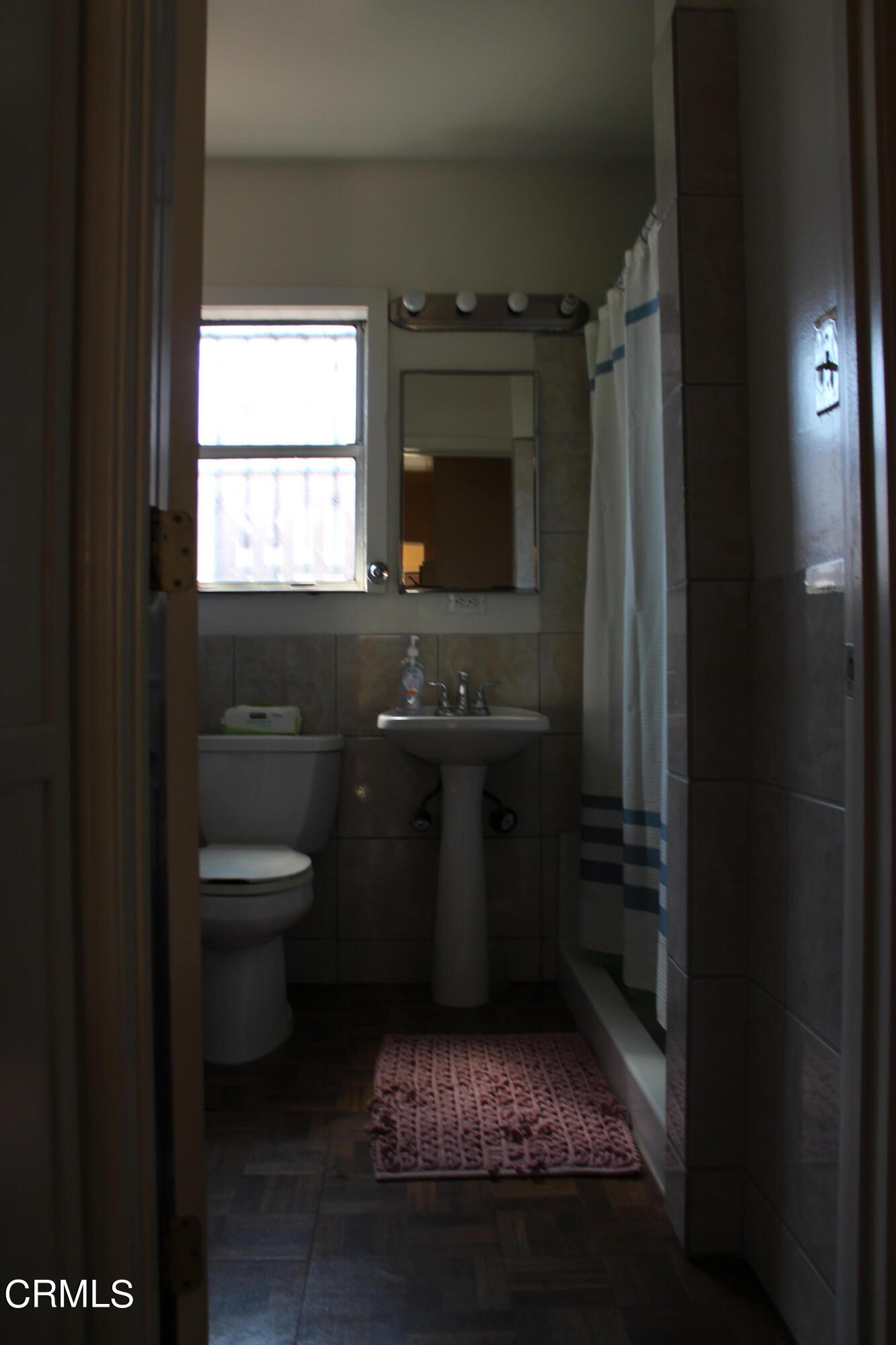 1111 South M Street Oxnard, CA 93033 - Photo 11 of 22 a bathroom with a sink toilet and window