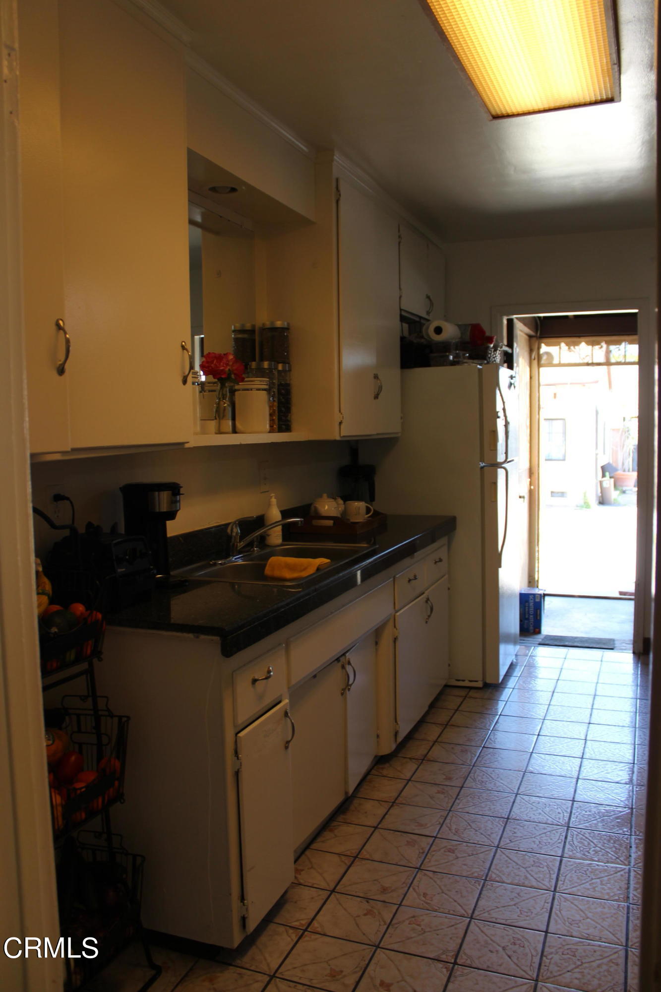 1111 South M Street Oxnard, CA 93033 - Photo 12 of 22 a kitchen with granite countertop a stove and a refrigerator