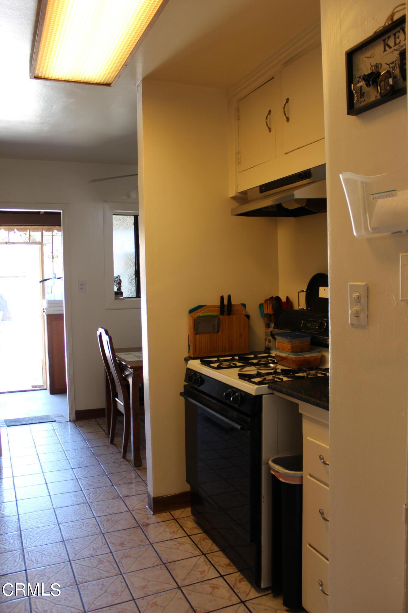1111 South M Street Oxnard, CA 93033 - Photo 13 of 22 a kitchen with a stove and a refrigerator