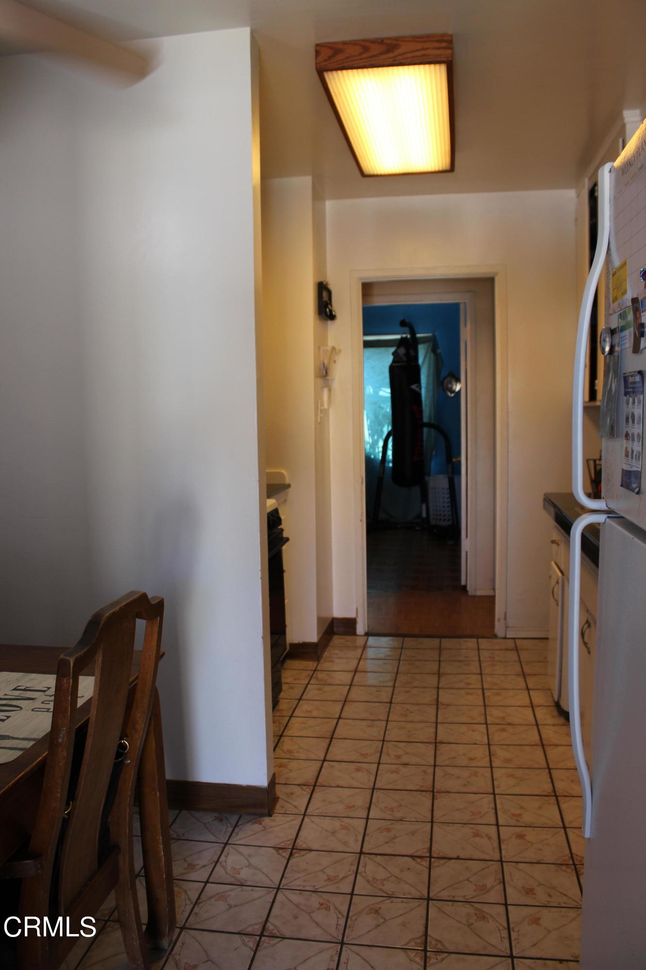1111 South M Street Oxnard, CA 93033 - Photo 15 of 22 a view of a hallway with wooden floor and a bathroom