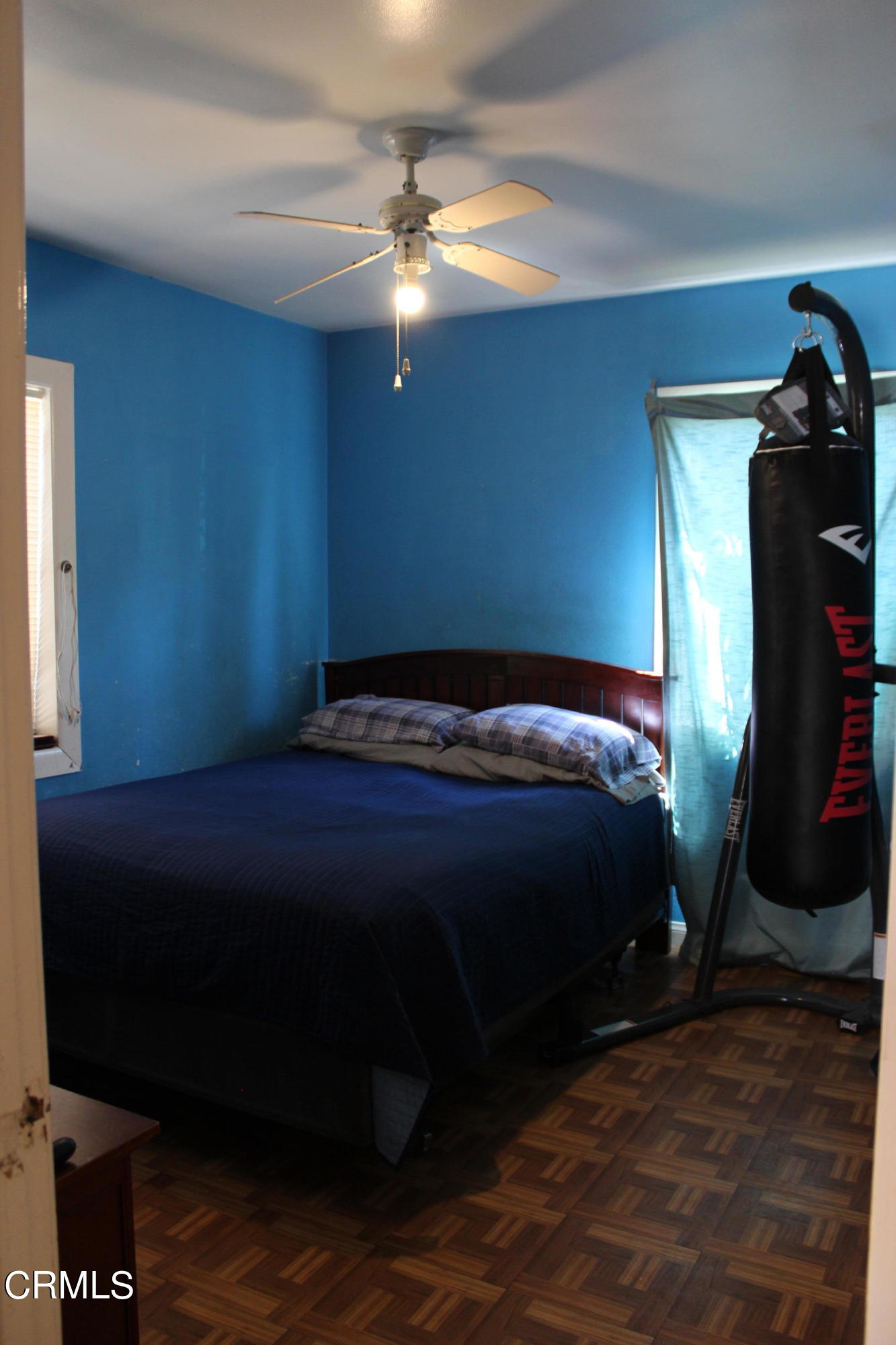 1111 South M Street Oxnard, CA 93033 - Photo 7 of 22 a bedroom with a bed and a chandelier